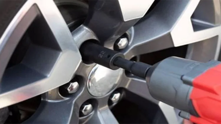 Using an impact wrench to remove a tire
