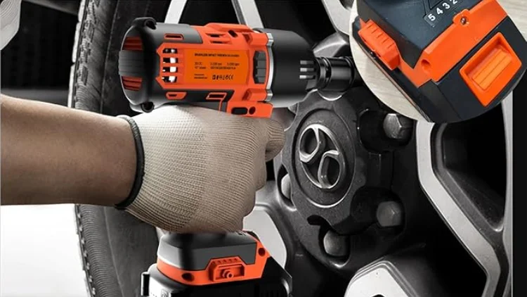 Use an impact wrench to remove the nut from the car tire.