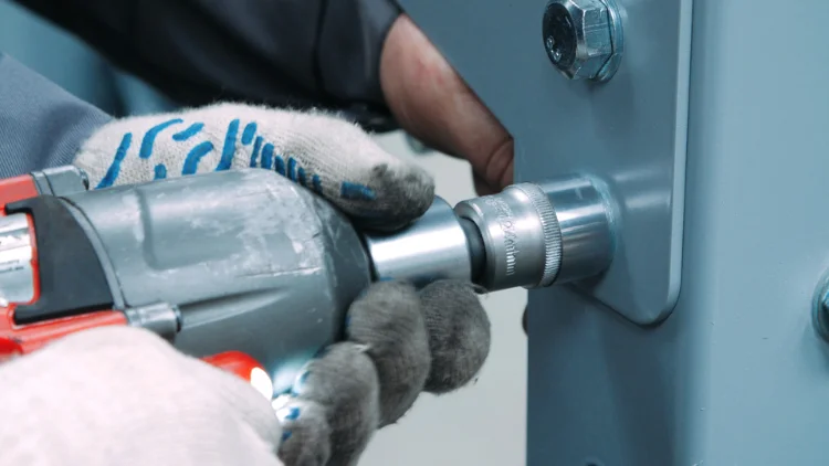 Using an impact wrench to tighten the nut