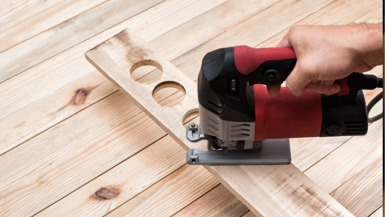 Jigsaw cutting circular holes in wooden board